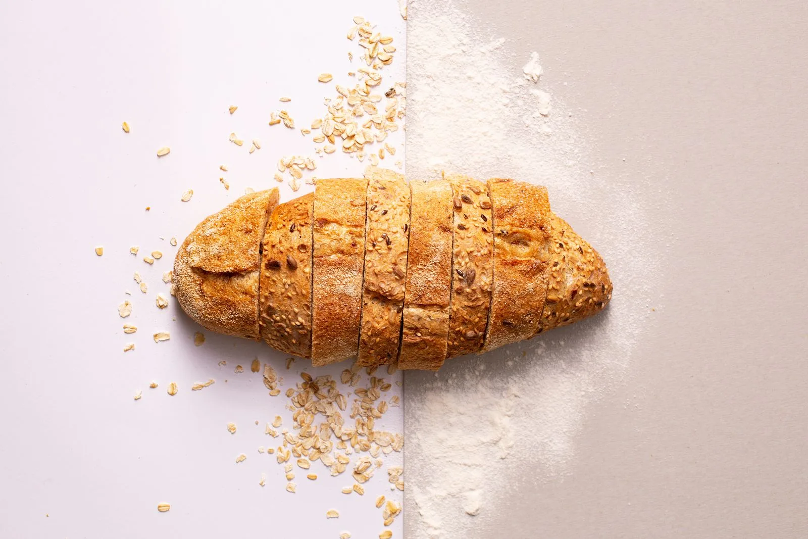 Freshly sliced multi-grain bread with flour and oats