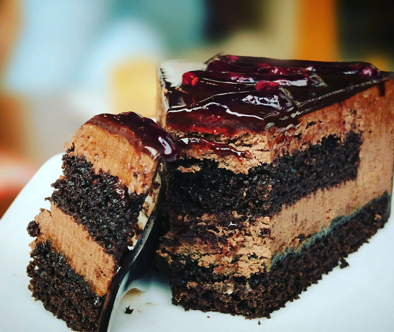 Rich chocolate cake being sliced